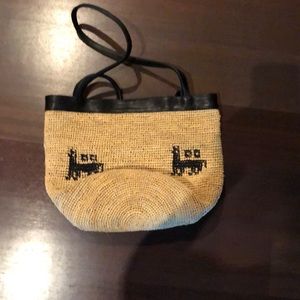 Straw bag with leather straps.